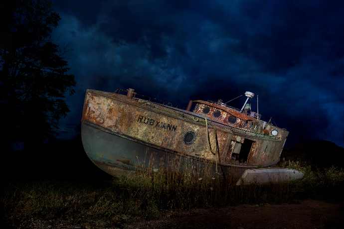 a boat sits on the side of a road